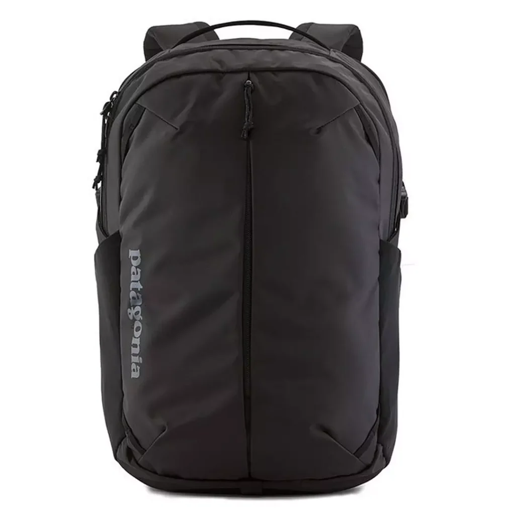 black backpack with top carry handle and zipper pulls, as well as a tonal dark grey/black "PATAGONIA" wordmark branding at the backpack's front-left; two large zip main compartments and a zipper down the centre front